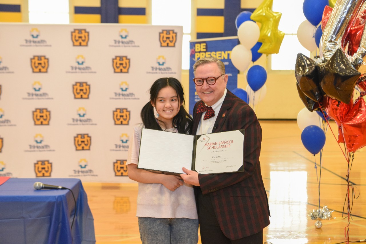 Jack Miner, Vice Provost for Enrollment Management surprised Uyen Dao future UC Bearcats with Marian Spencer Scholarship awards at Walnut Hills High School Tuesday January 31, 2023. Marian Spencer Scholarship  award students with full tuition, room and board and an all-expenses-paid study abroad experience from the University of Cincinnati. Photos by Joseph Fuqua II