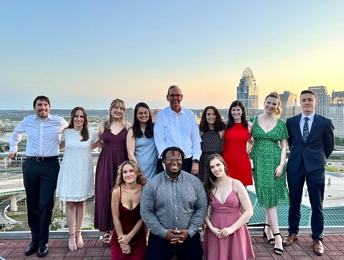 Several students stand together on the Banks overlooking downtown Cincinnati.