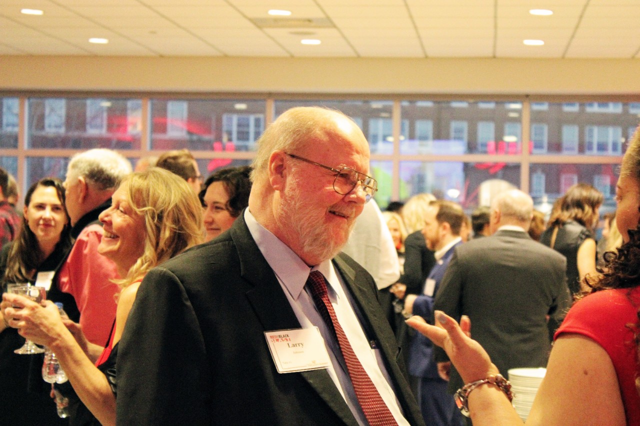 Lawrence Johnson, Dean of CECH, converses with attendees and students at the 2023 Red and Black Blast. 