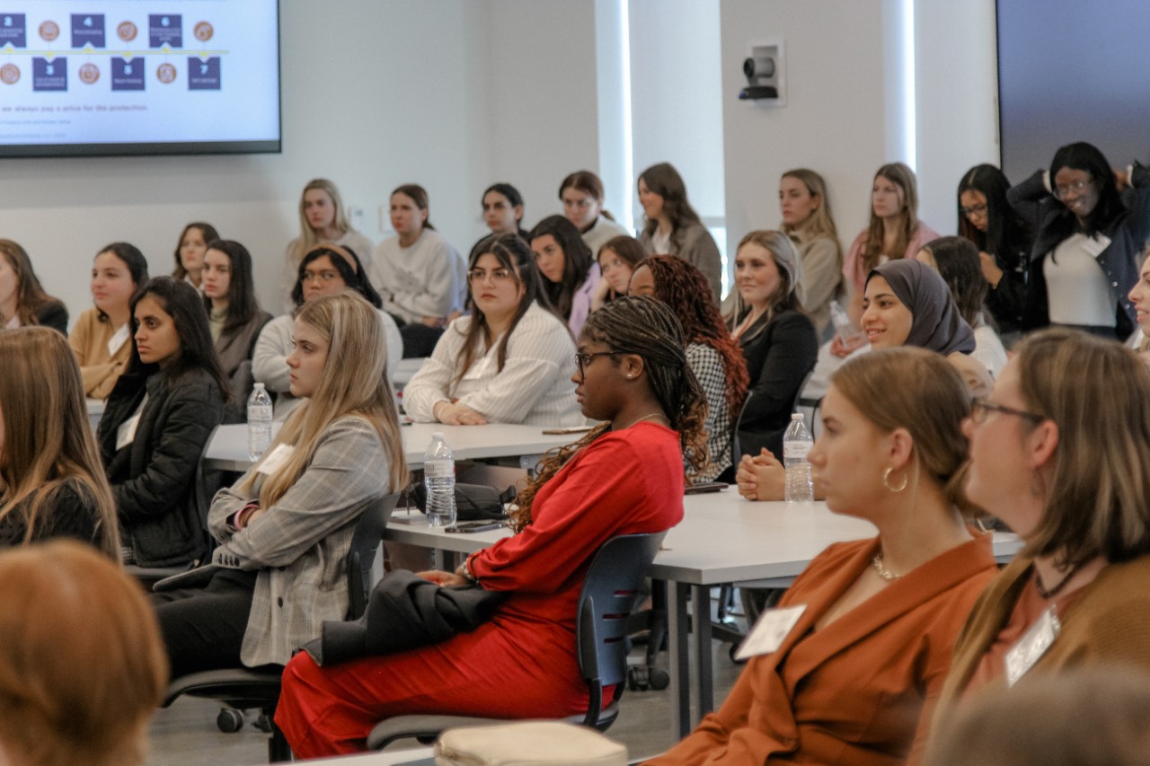 A group of diverse students sit in a Lindner Hall classroom