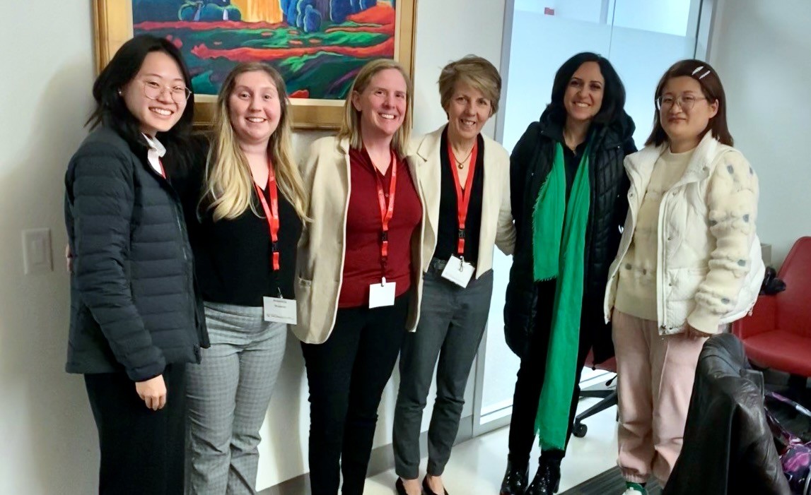 Six women stand together at a pharmacy conference.