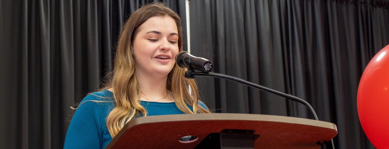 UC Clermont scholarship recipient Ayla Deck speaks at the college's 2023 Community Celebration Luncheon.