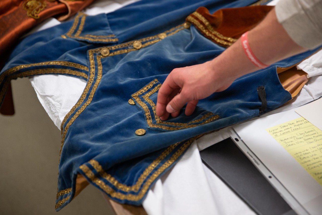 Assistant Professor of Art History Chris Platts takes his Honors Program Seminar students to uncover the hidden collections of UC and the hidden stories that accompany many of the items, artifacts, instruments, costumes, and other things squirreled away in various buildings, libraries, and depositories on campus. Here they visit CCM’s Special Collections at the Albino Gorno Memorial Library and the Historic Costume Collection in Theatre Arts.