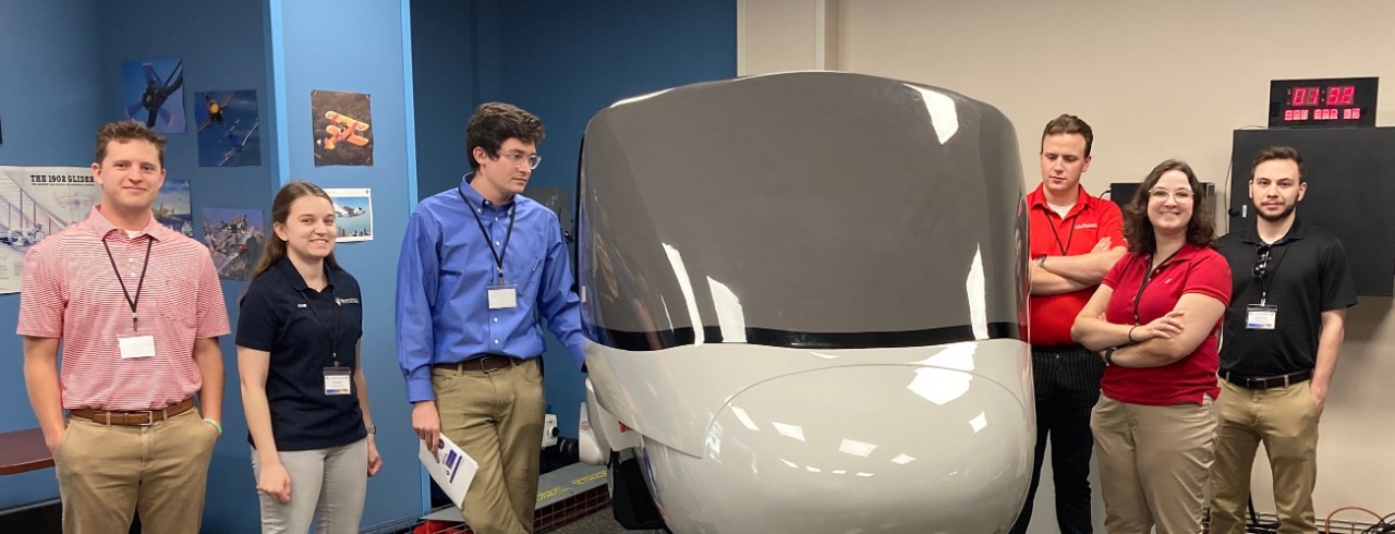 IT FLIES team members from left to right: Will Hausfeld, Emma Ochs, Liam Mckenna, Jackson Dinga, Grace Fischer and Daniel Driscoll. Pictured next the cockpit during flight. 