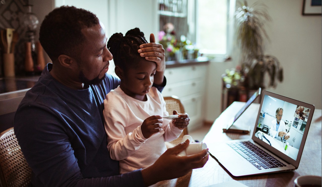 A parent with a sick child communicates with a doctor over a webchat.