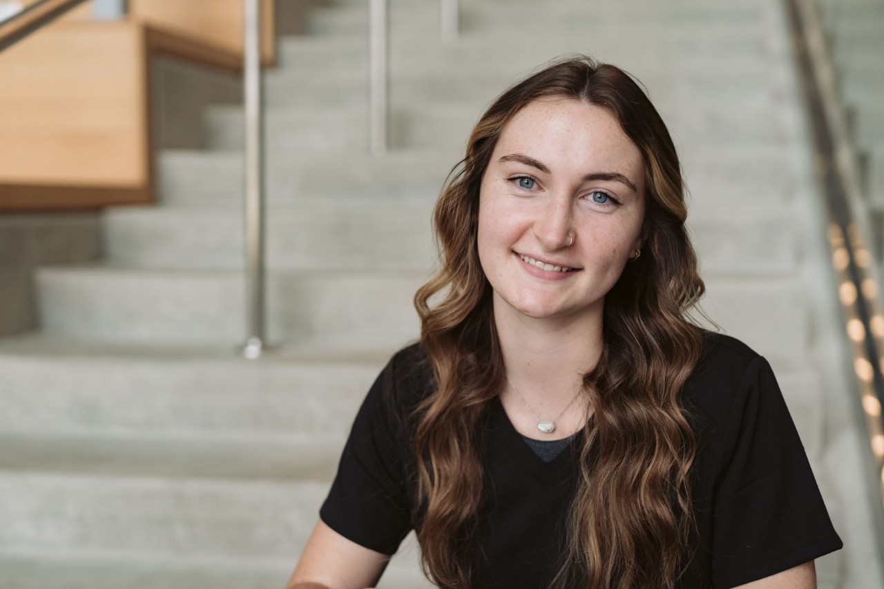 Lisa Harris, recipient recipient of the Stewart-Adams Bearcat Buddies Tutor of the Year Award, sits on steps in the Health Science Building 