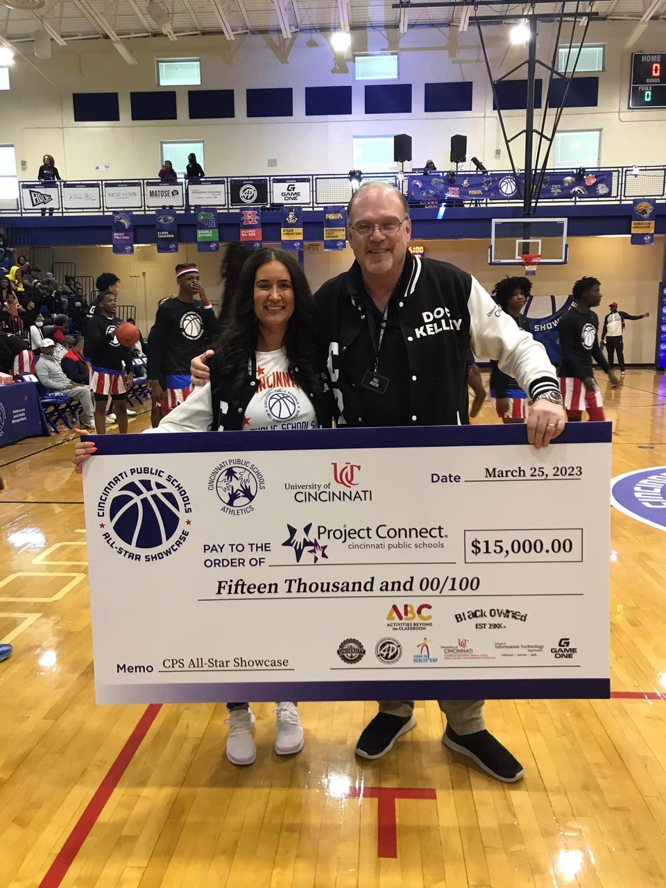 Photo of Dr. Kelley presenting Project Connect with $15,000 check at the CPS All-Star event.