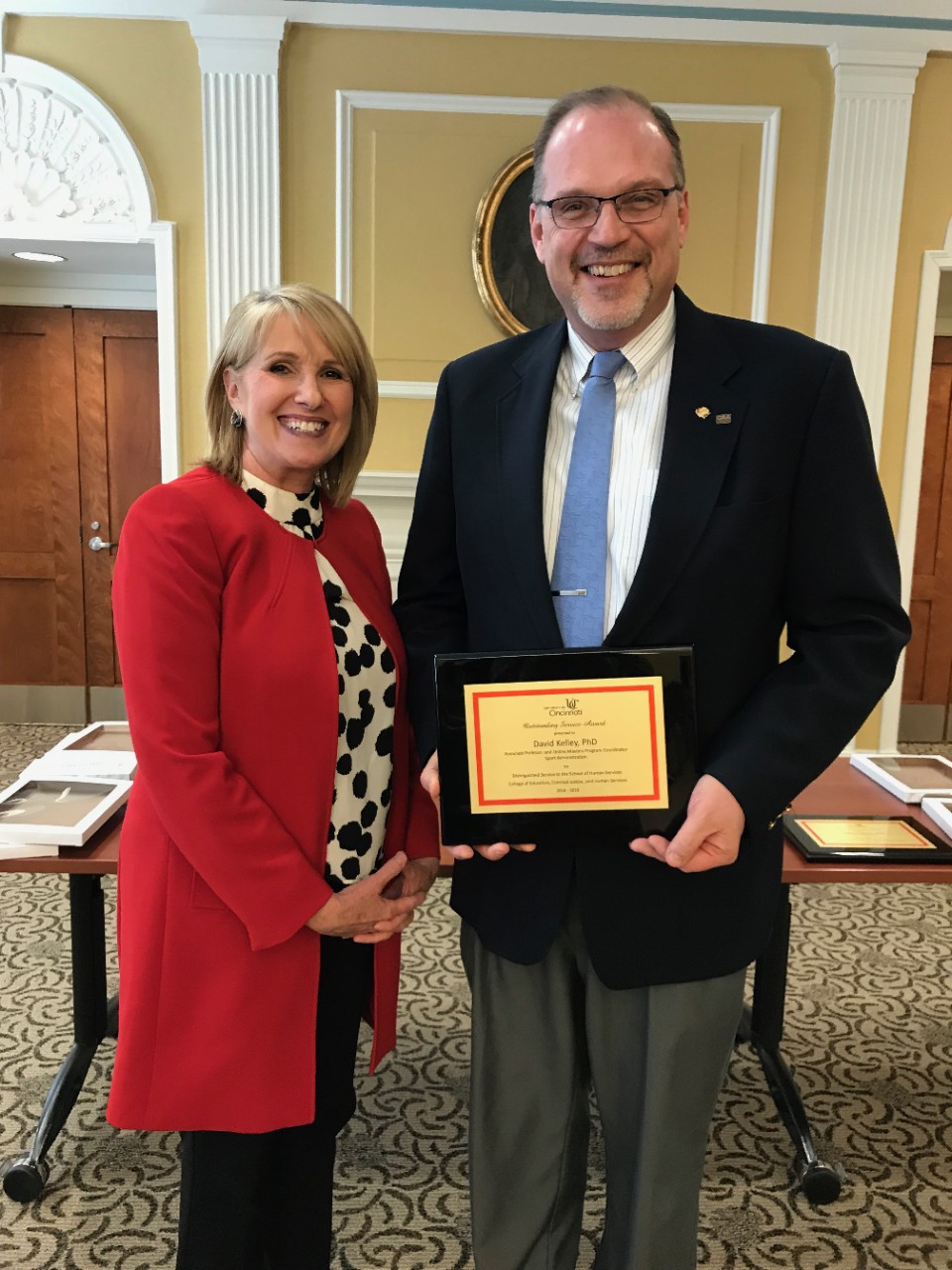Photo of Dr. Kelley receiving an outstanding service award. 