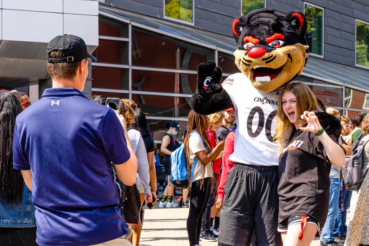A student's family member takes a photo of them with the Bearcat during the Pep Rally on Mainstreet on Friday, September 16.