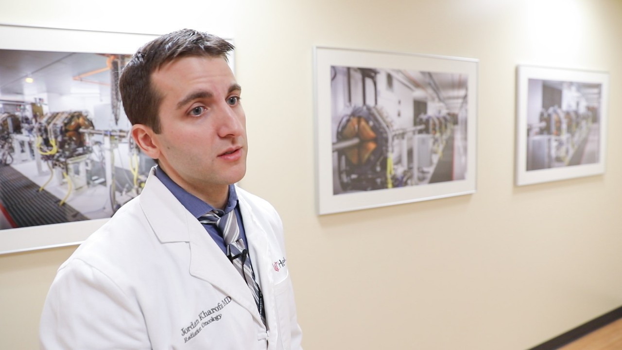 Dr. Jordan Kharofa  shown in a white physician's coat.