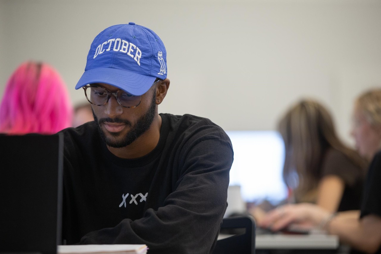 A male UC student shown in a psychology class during the first couple of weeks of the semester.