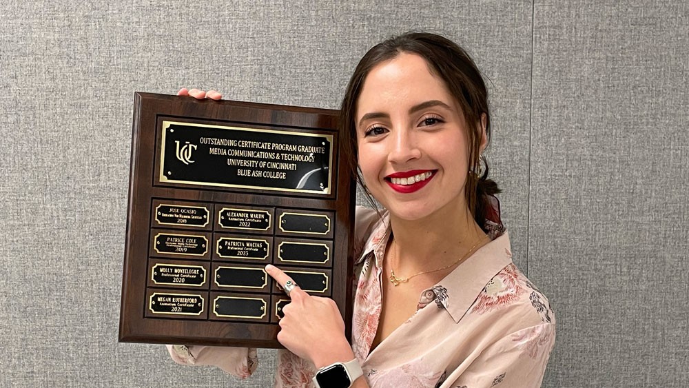 Patricia Macias posing with her award