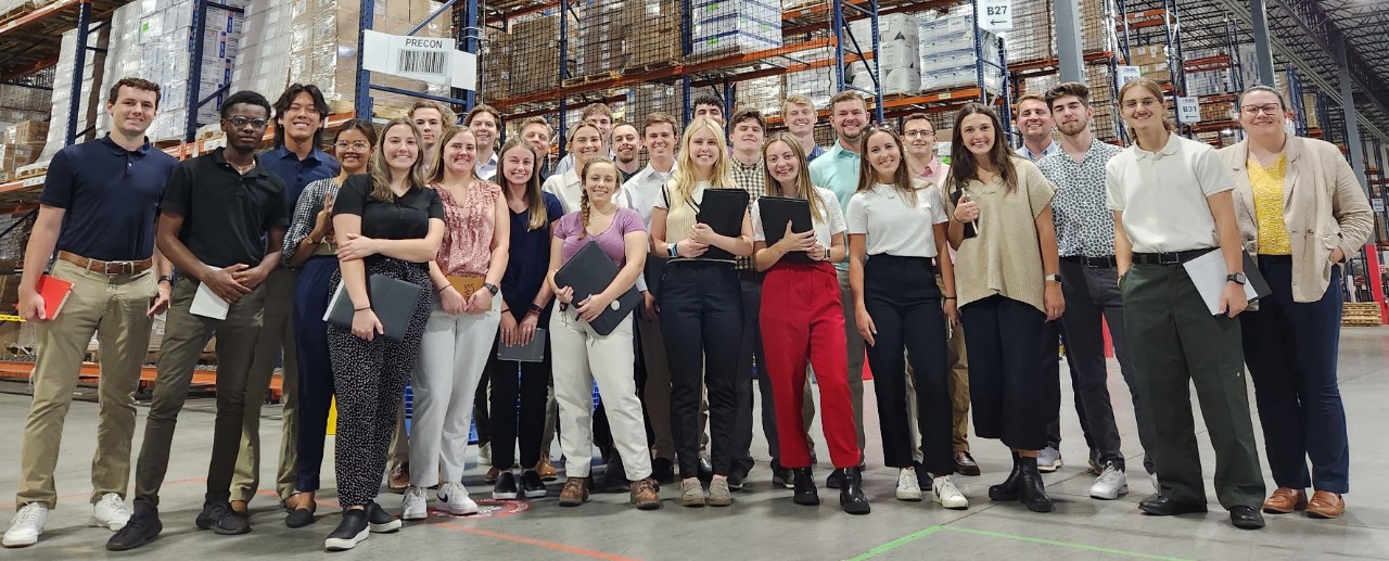 Lindner students in a Cintas distribution center warehouse.