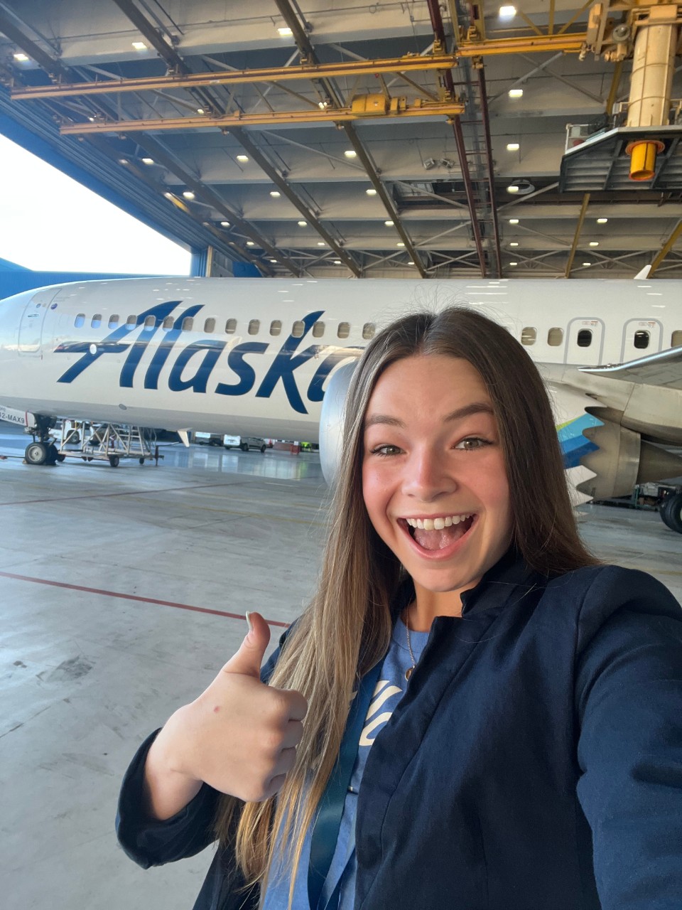 Madison Byrd pictured in front of Alaska Airlines aircraft. 