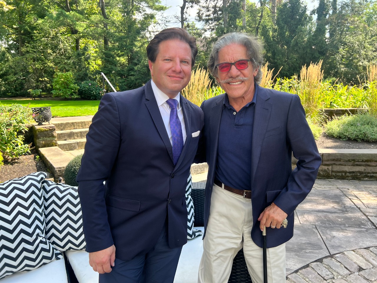 Brian Calfano at left with Geraldo Rivera in a garden setting