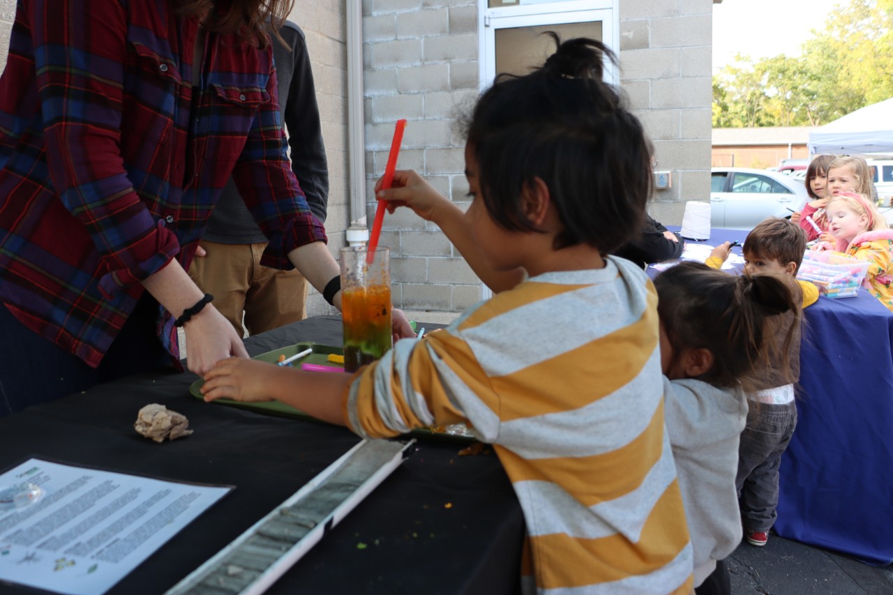 Children engage with a colorful experiment on sediment coring. Credit/Hannah White