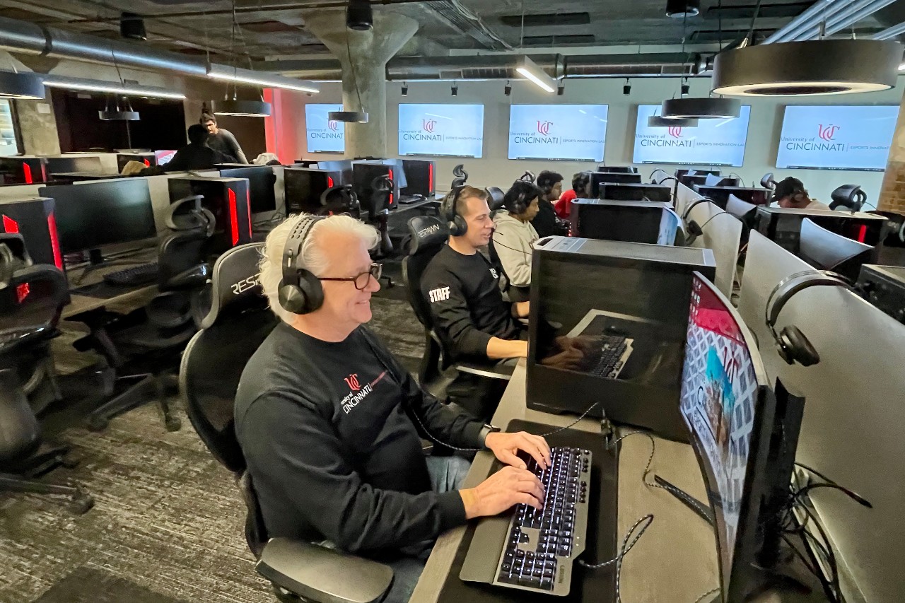 Two men play video games in UC's 1819 iHub ESports Lab.