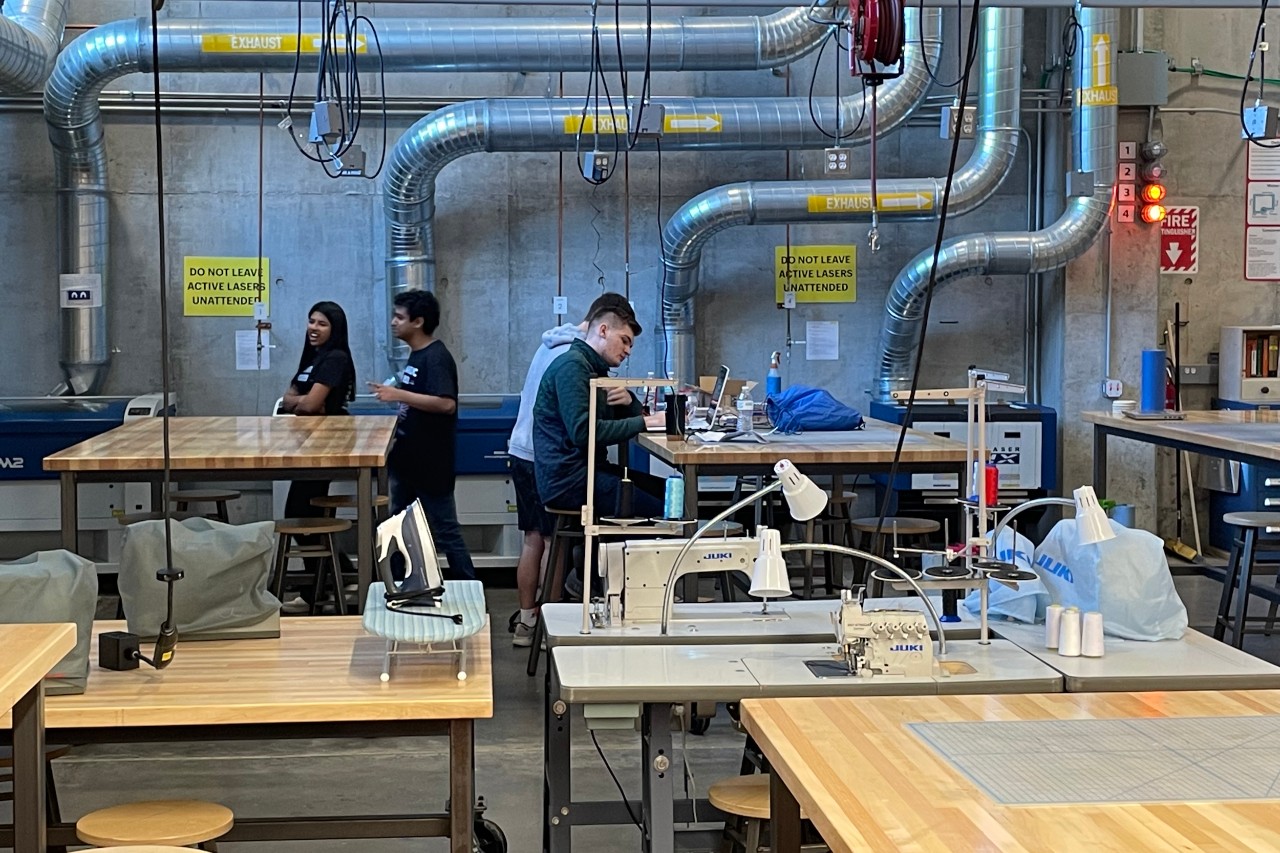 Students work on CNE machines in UC's 1819 iHub Makerspace.