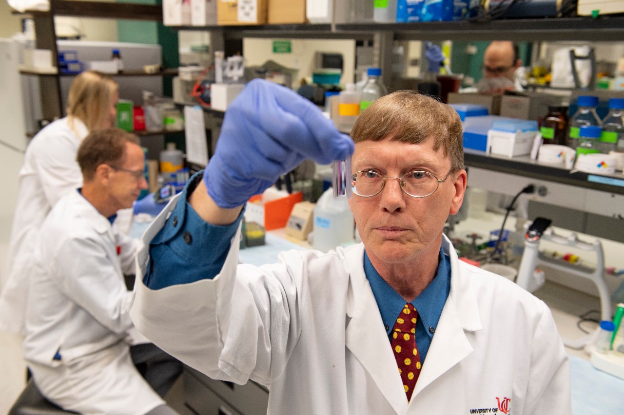 Andrew Norman, PhD, working in his lab with team.