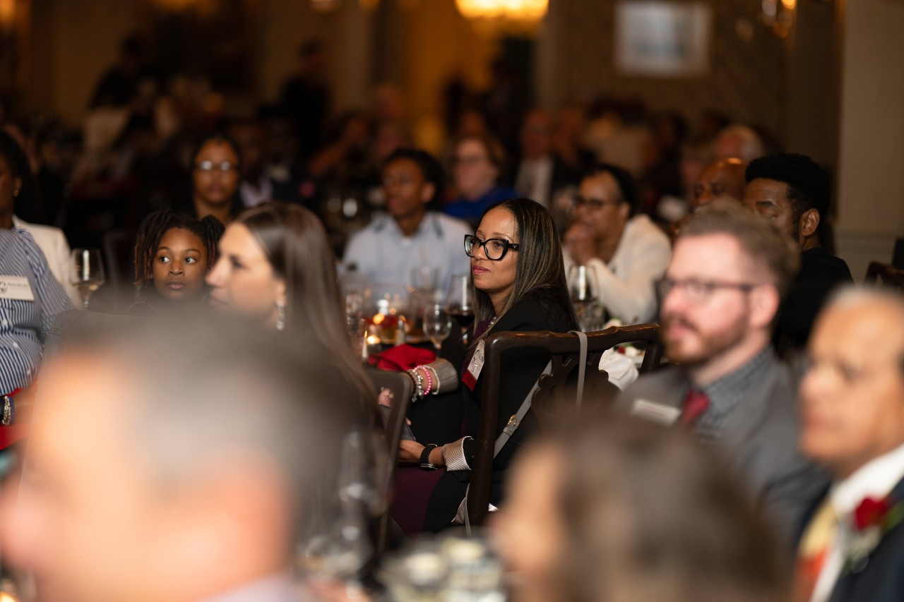 Gloria Samuel looks on while someone speaks at the awards dinner