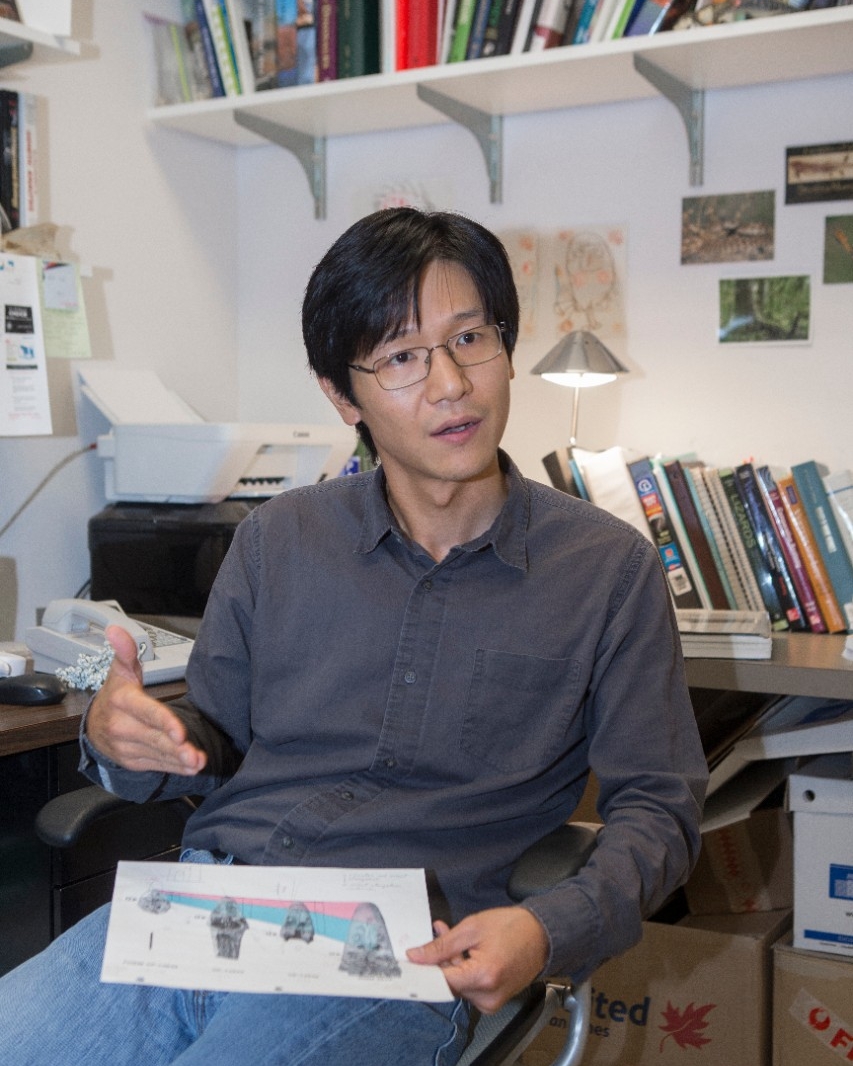 UC biology professor Takuya Konishi shown here in his off and his lab with a Mosasaur fossil at Rievschl. UC/Joseph Fuqua II