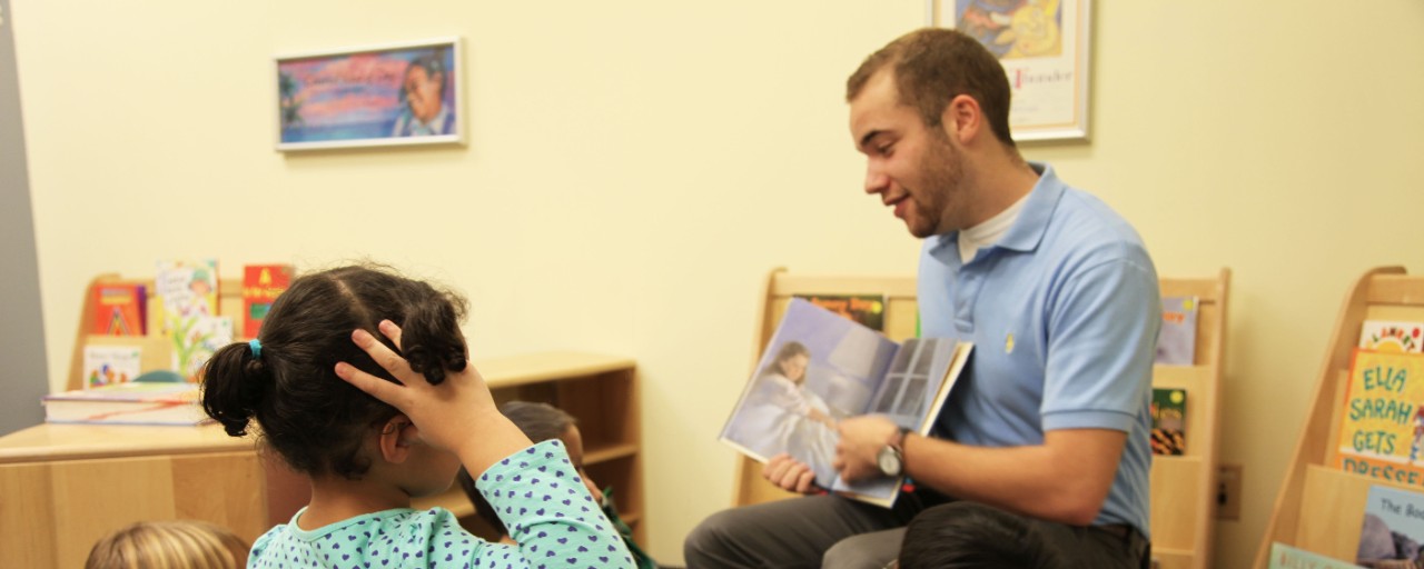 Featured image at top: Elementary Education student reads a book to children during an experiential learning opportunity. Photo/provided.