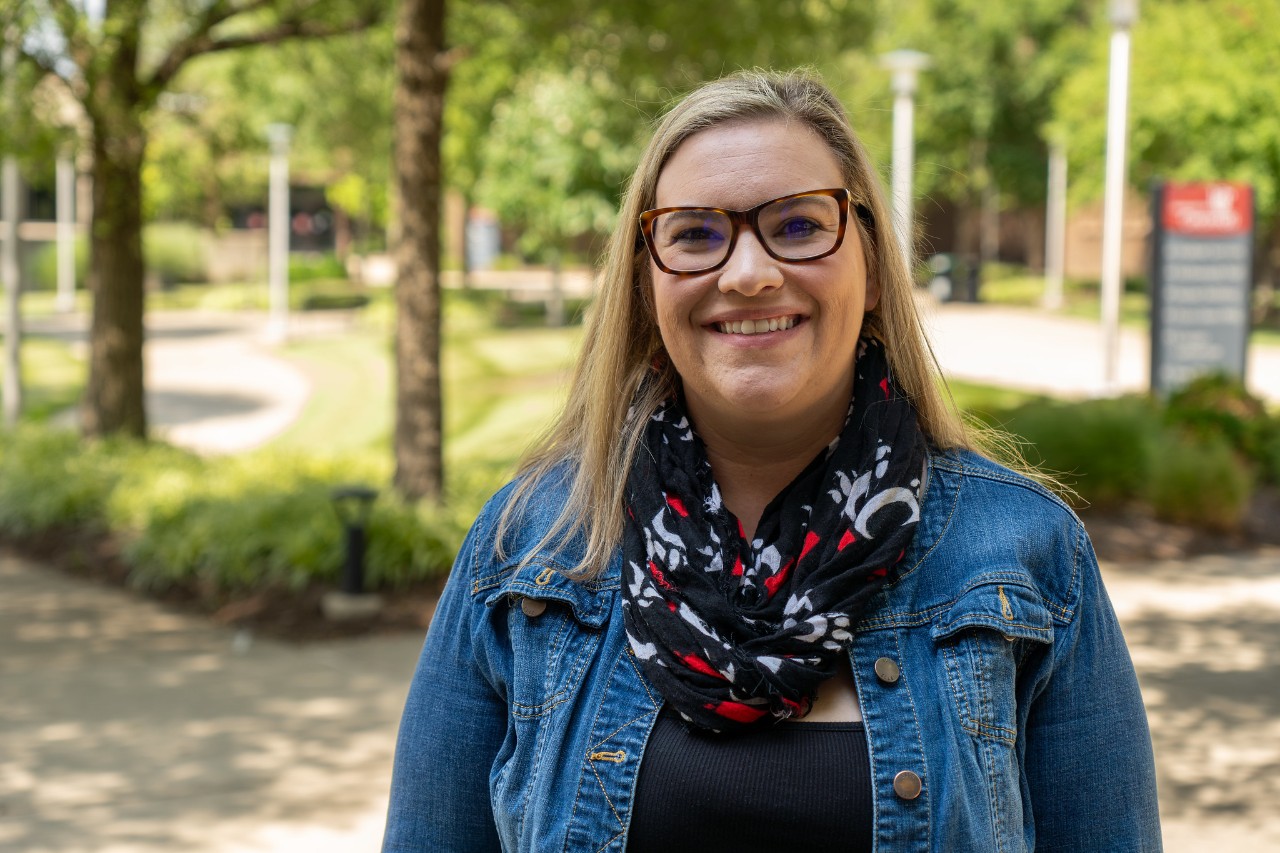 student smiling outside on campus