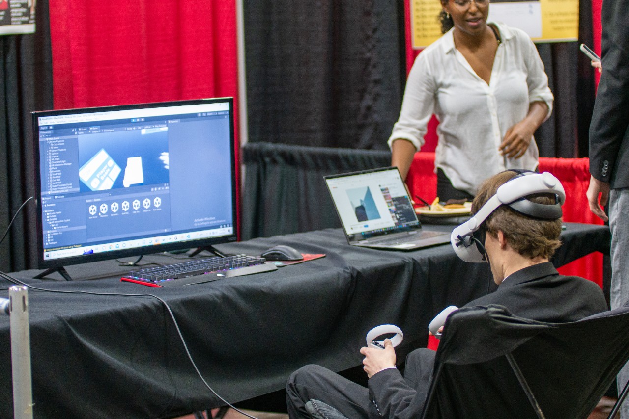 Expo attendee uses VR student project