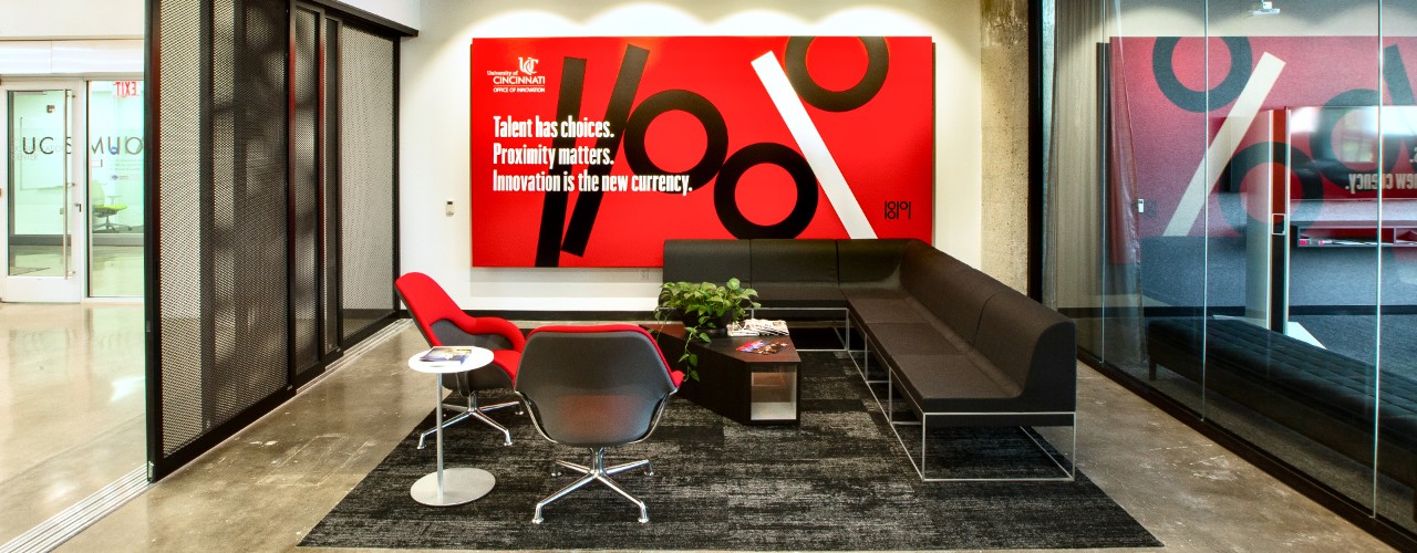Glass walls and furniture inside a meeting space in UC's 1819 Innovation Hub.