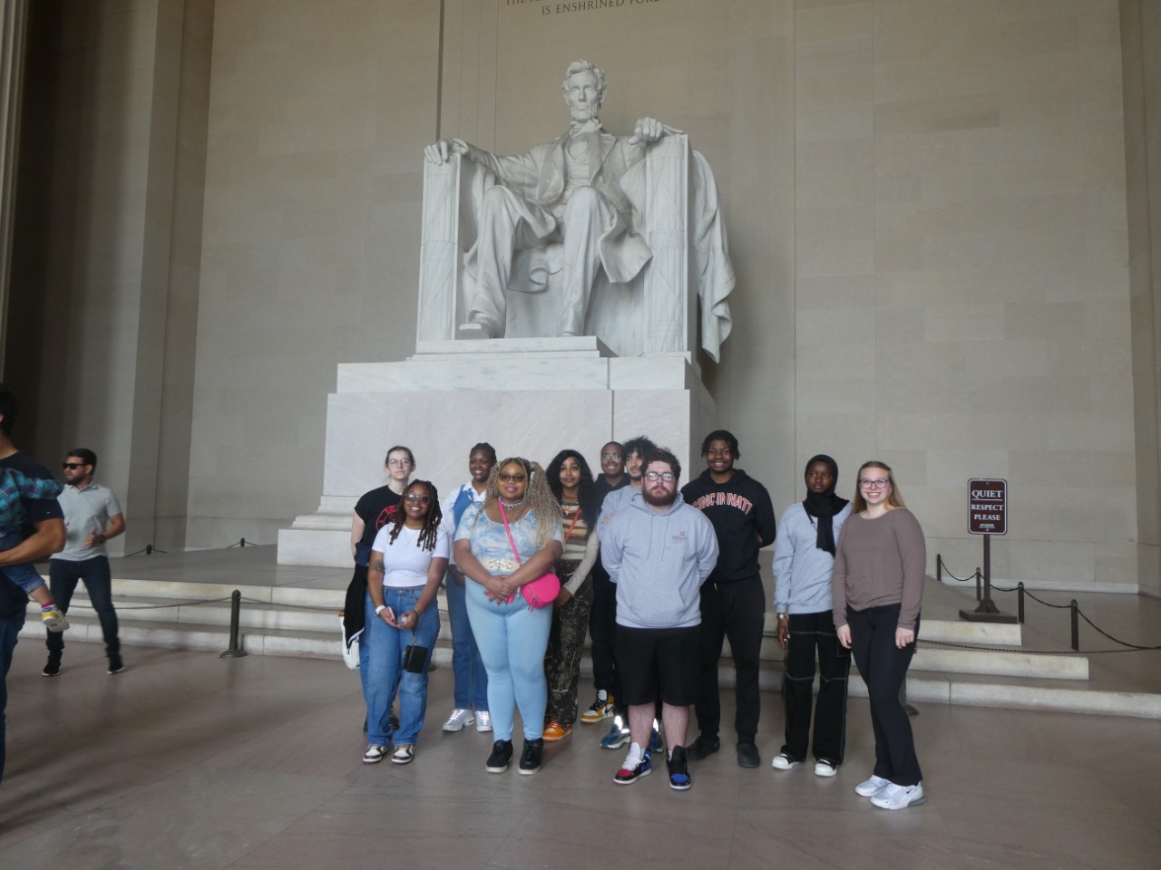 Eleven students part of the Marian Spencer Scholarship program stand in front of the Lincoln Monument in DC