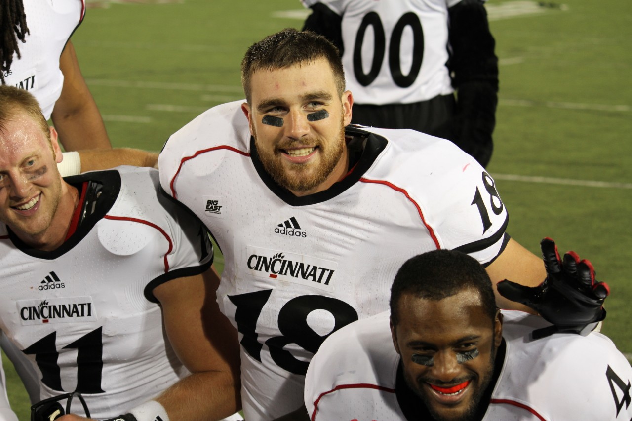 Travis Kelce as a UC Bearcat in his football uniform with teammates