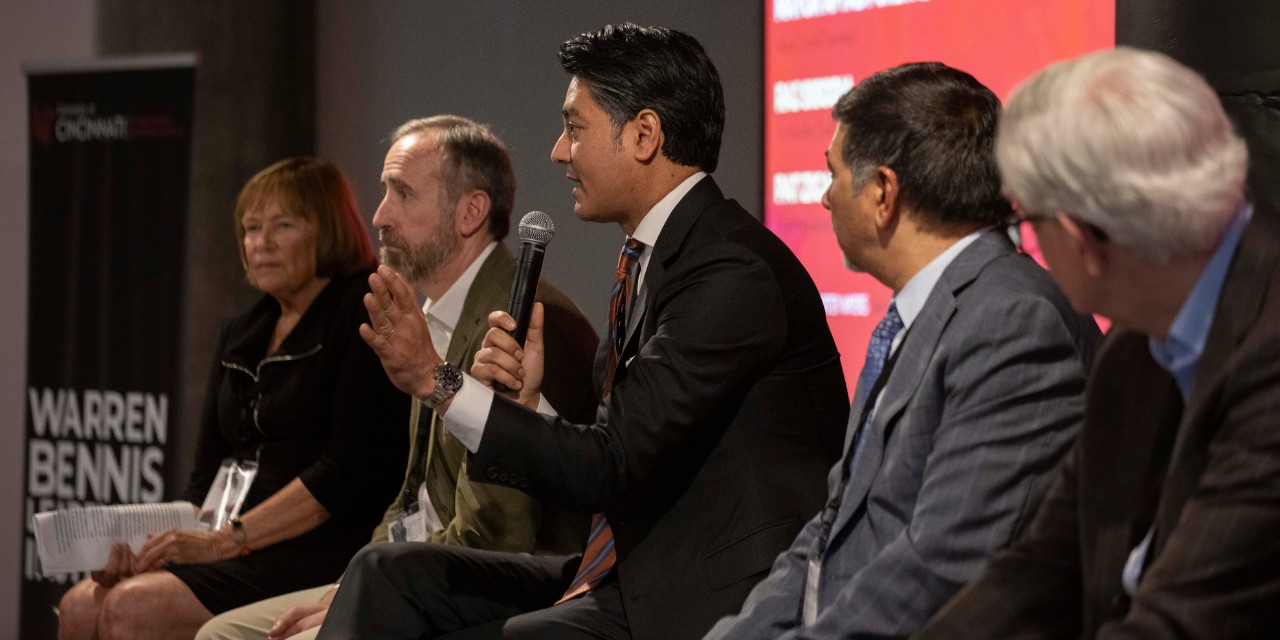 The mayor of Cincinnati addresses the crowd as his fellow panelists look on.