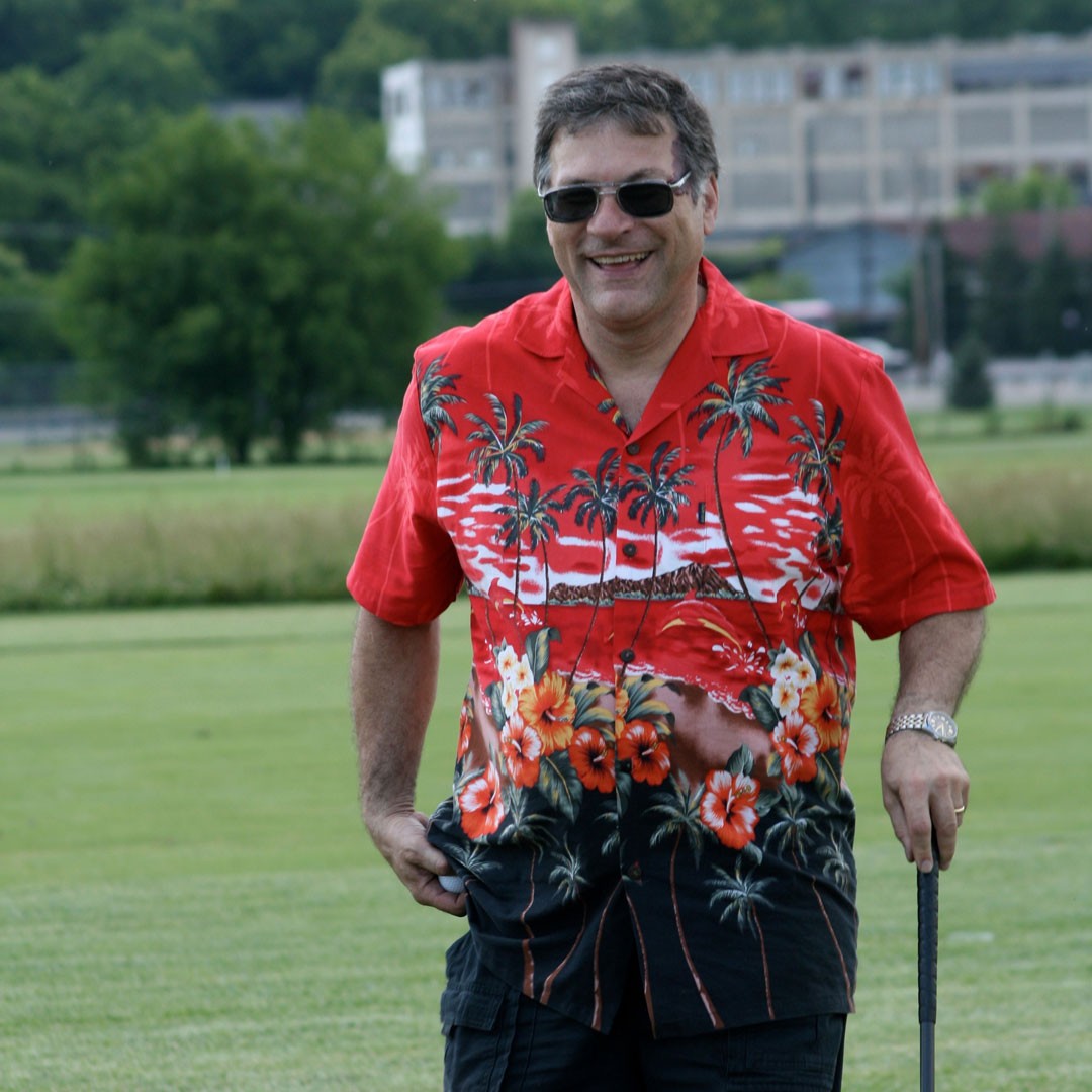 Ed Latessa in floral shirt holding a golf club