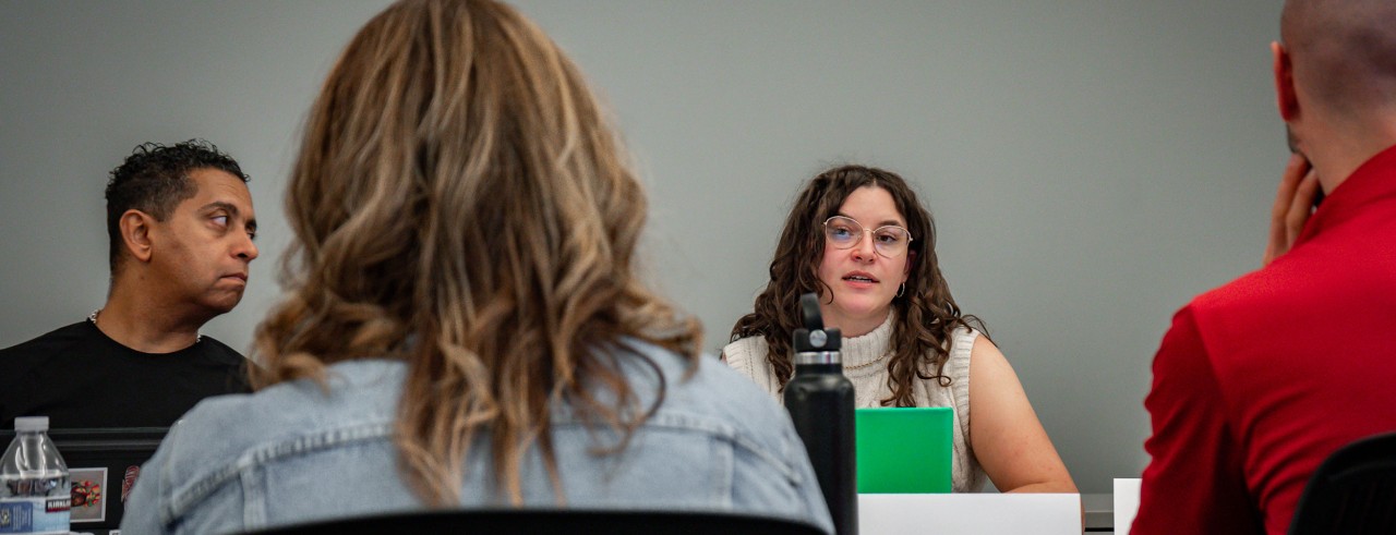 students in discussion at table