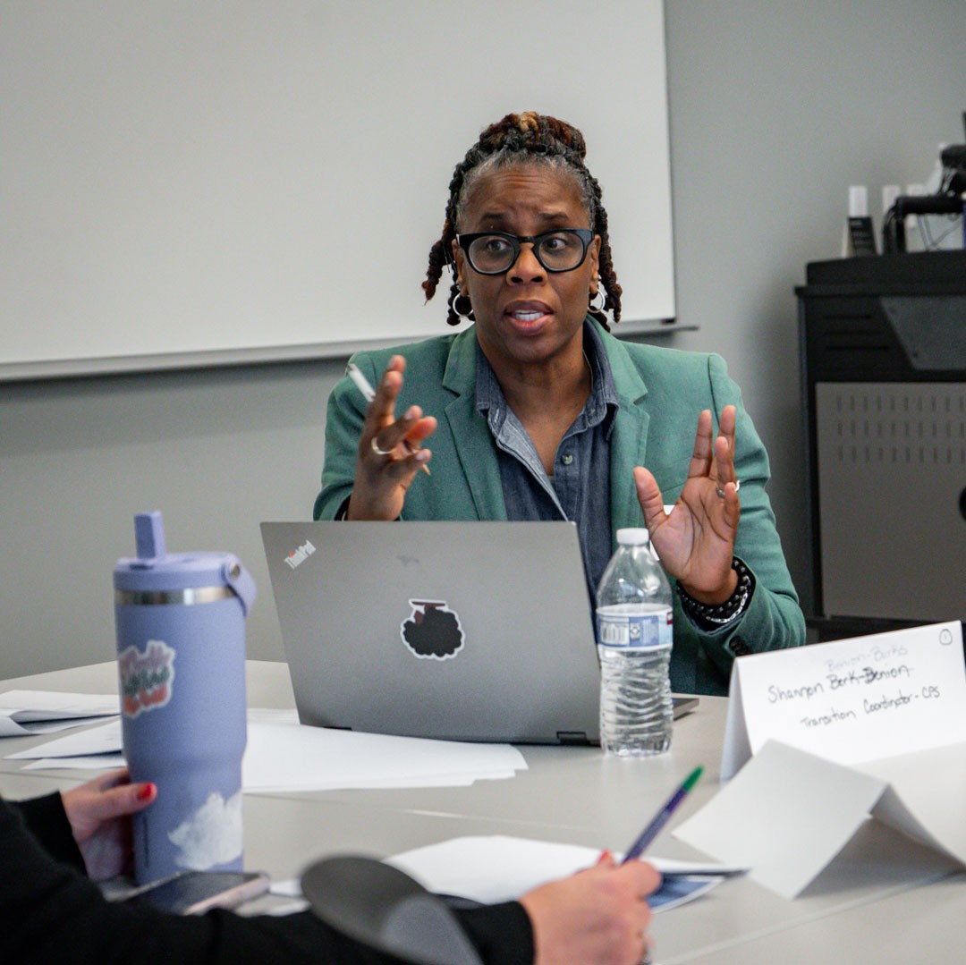 woman with open laptop speaking