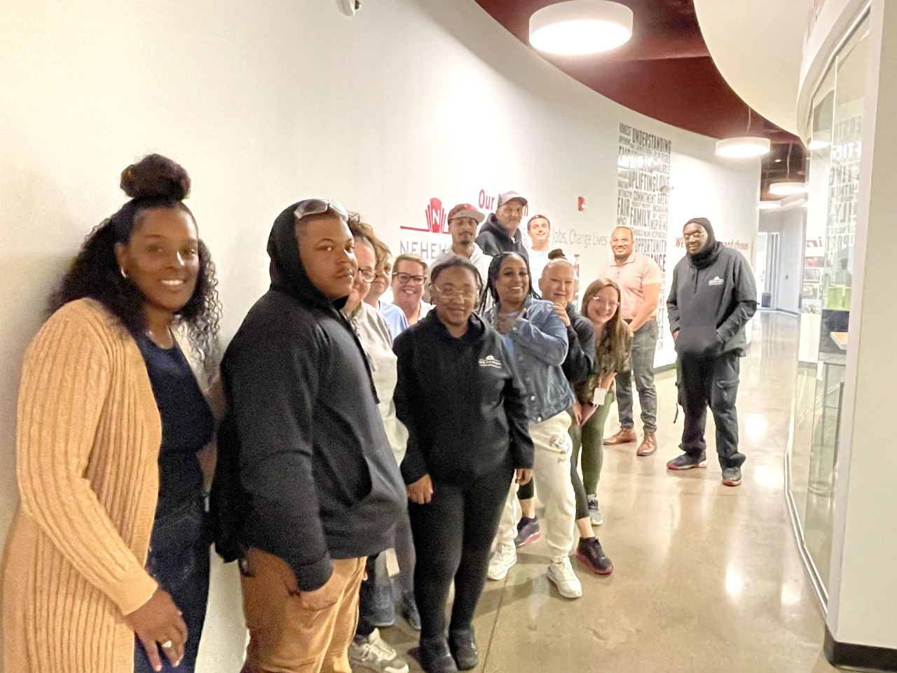 multiple students at Nehemiah Manufacturing wait in line for class to start