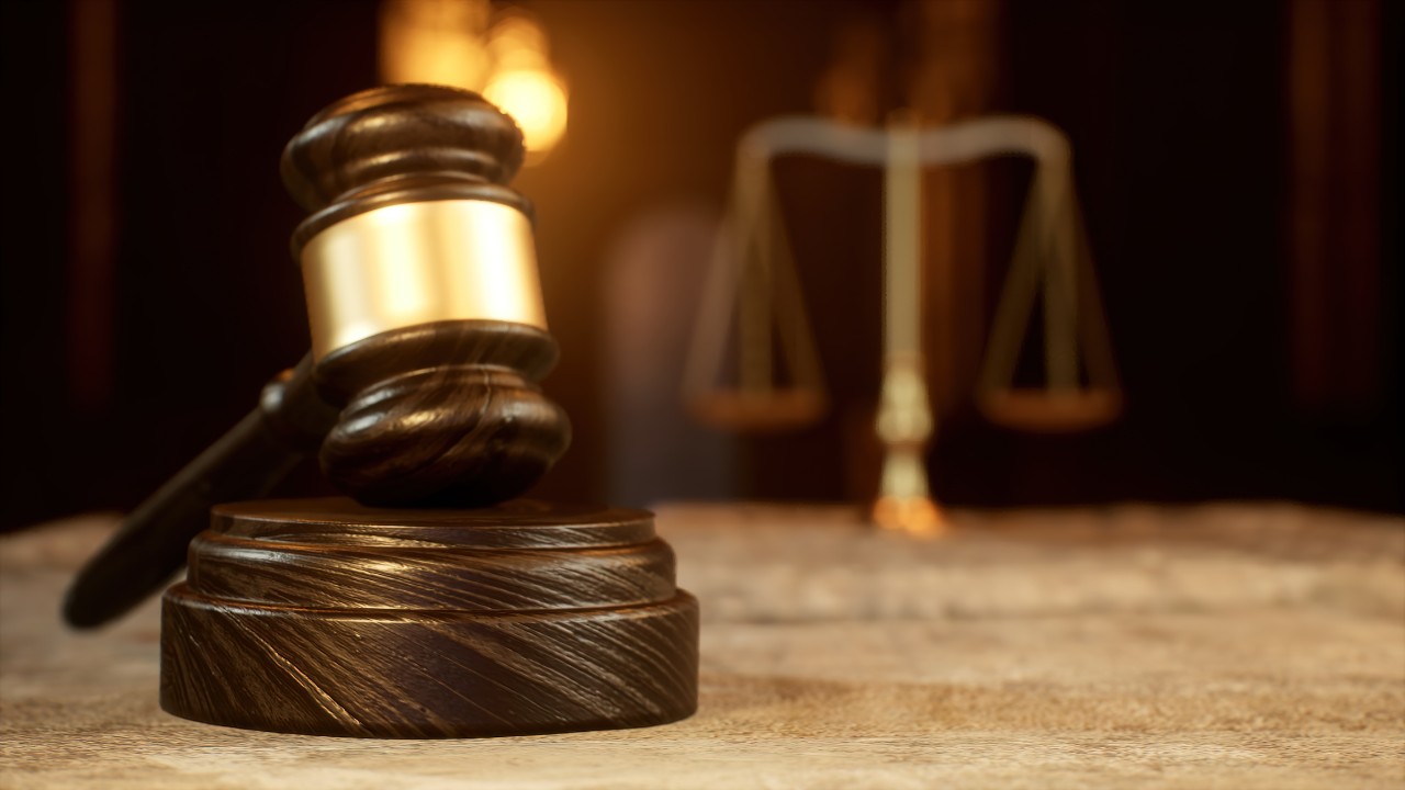 image of a gavel and scales of justice in the background