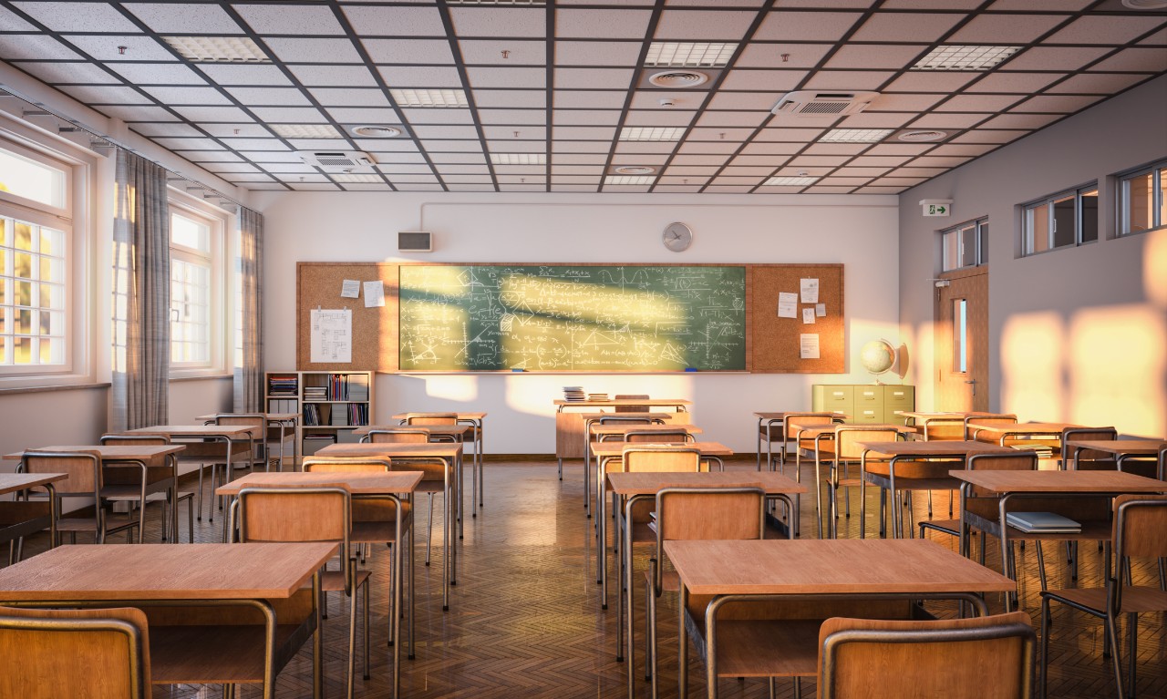 view of classroom with desks and a chalkboard 