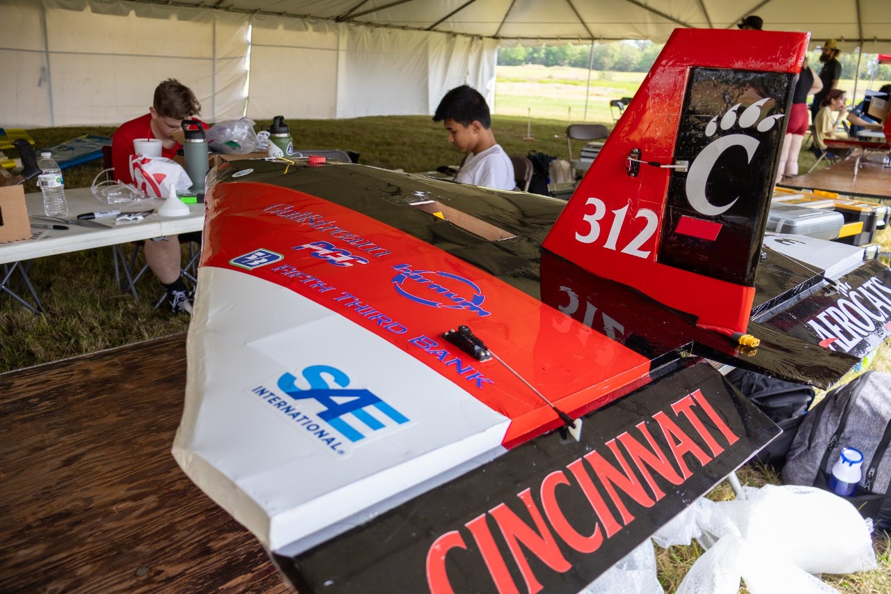 Aerocats micro plane sits on a table. It reads "Cincinnati" on the tail