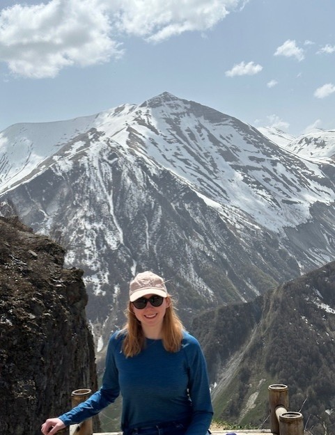 Burbage stands with the Caucasus mountains in the background