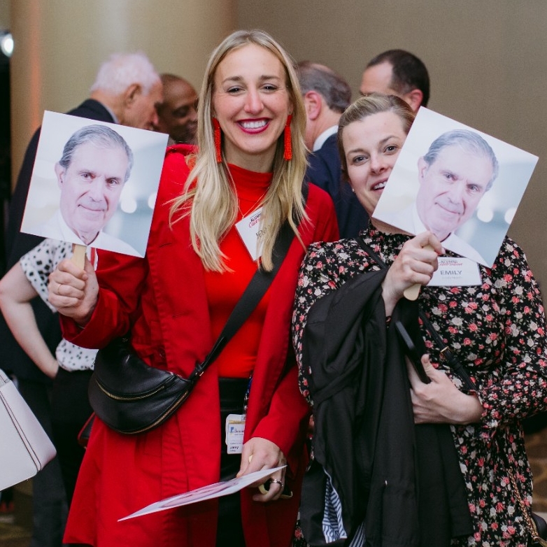 two woman holding sign's with Dr. Kereiakes' head