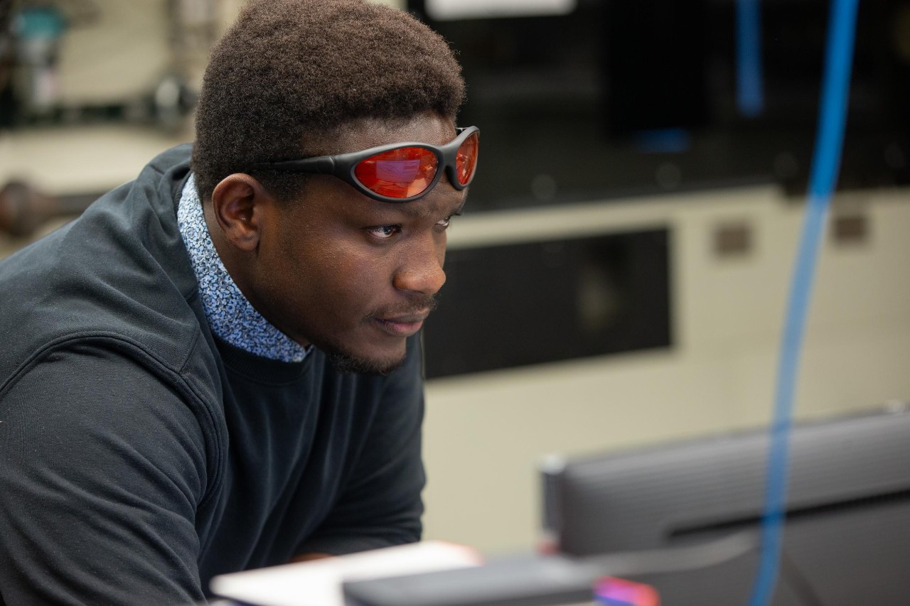 UC Aerospace Engineering student Vincent Onoja and UC Professor Daniel Cuppoletti (not pictured) developed a novel way to test the air flow in a jet engine nozzle using lasers and high-speed cameras. (Also pictured is doctoral student Keerthan Ganeshan)