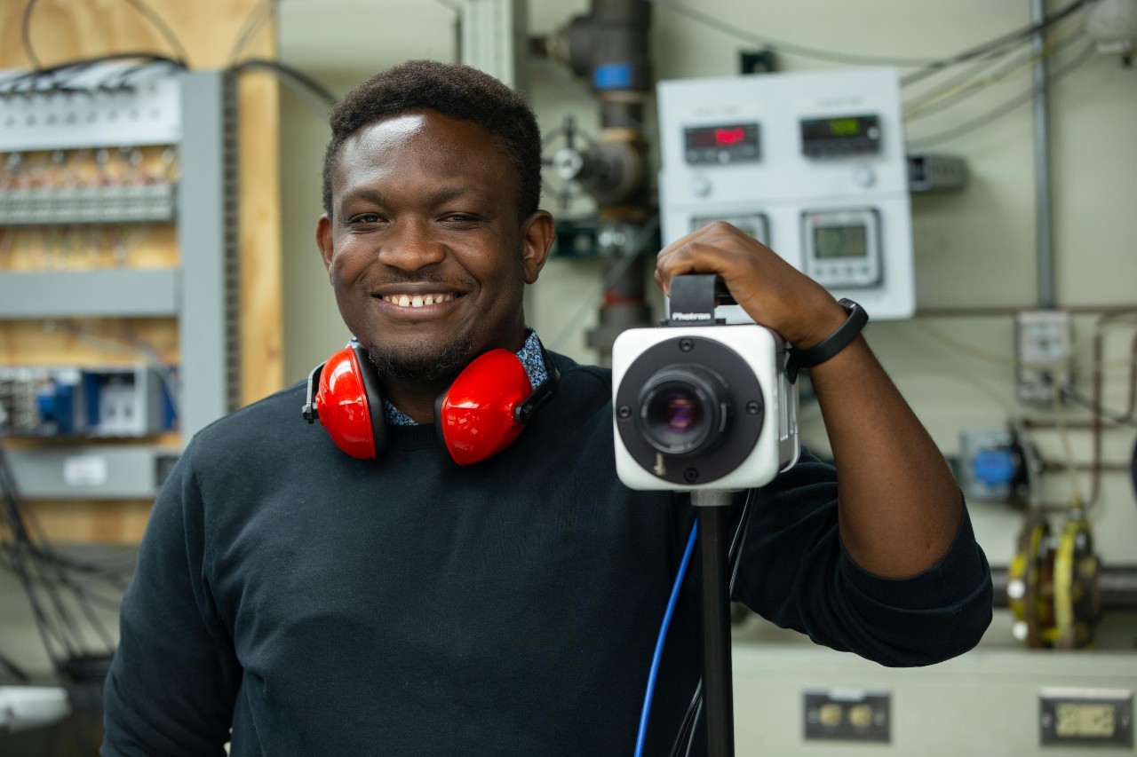 UC Aerospace Engineering student Vincent Onoja and UC Professor Daniel Cuppoletti (not pictured) developed a novel way to test the air flow in a jet engine nozzle using lasers and high-speed cameras. (Also pictured is doctoral student Keerthan Ganeshan)
