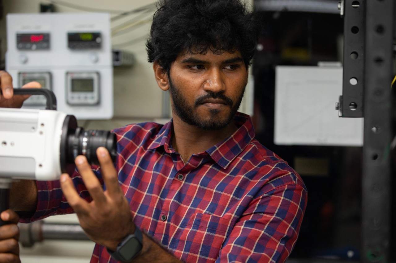 UC Aerospace Engineering student Vincent Onoja and UC Professor Daniel Cuppoletti (not pictured) developed a novel way to test the air flow in a jet engine nozzle using lasers and high-speed cameras. (Also pictured is doctoral student Keerthan Ganeshan)