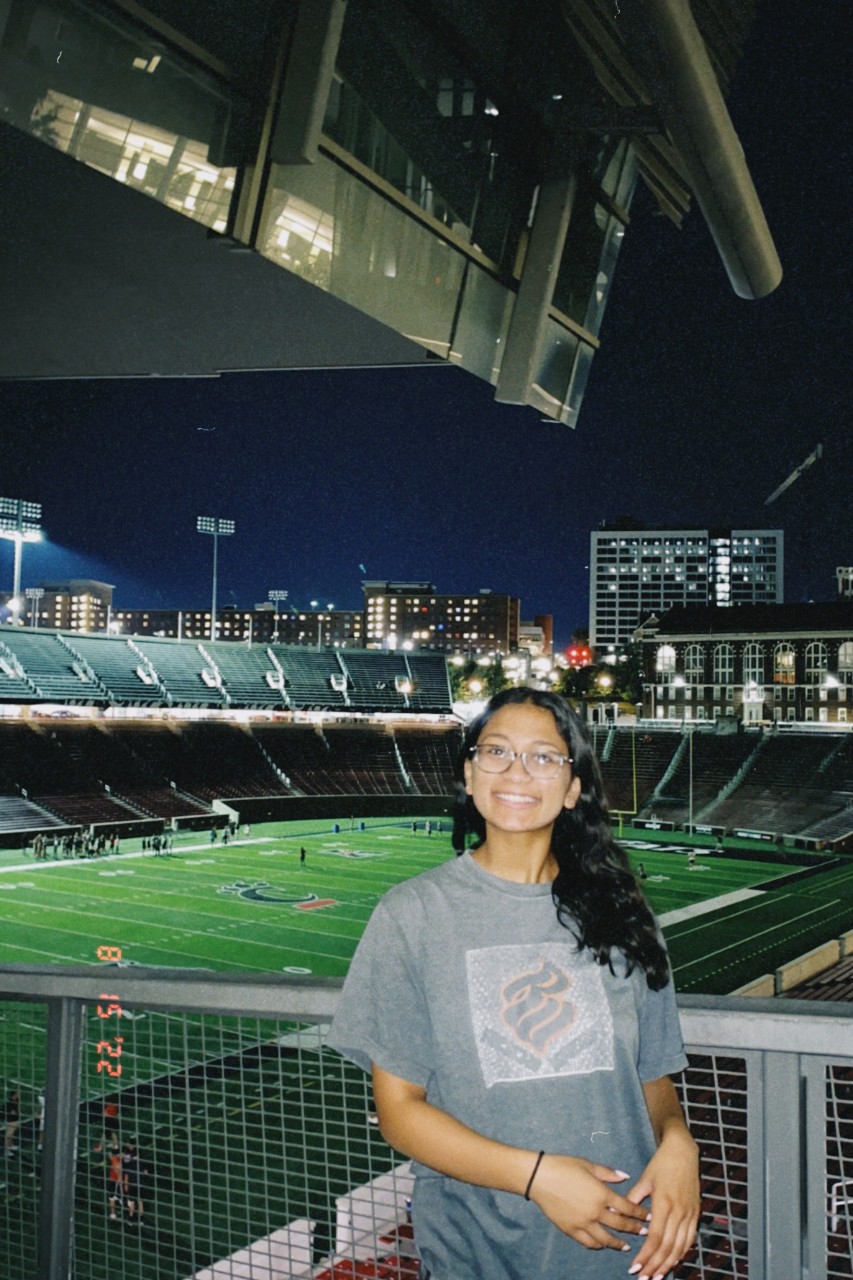 Aradana Nair poses in front of UC's Nippert Stadium