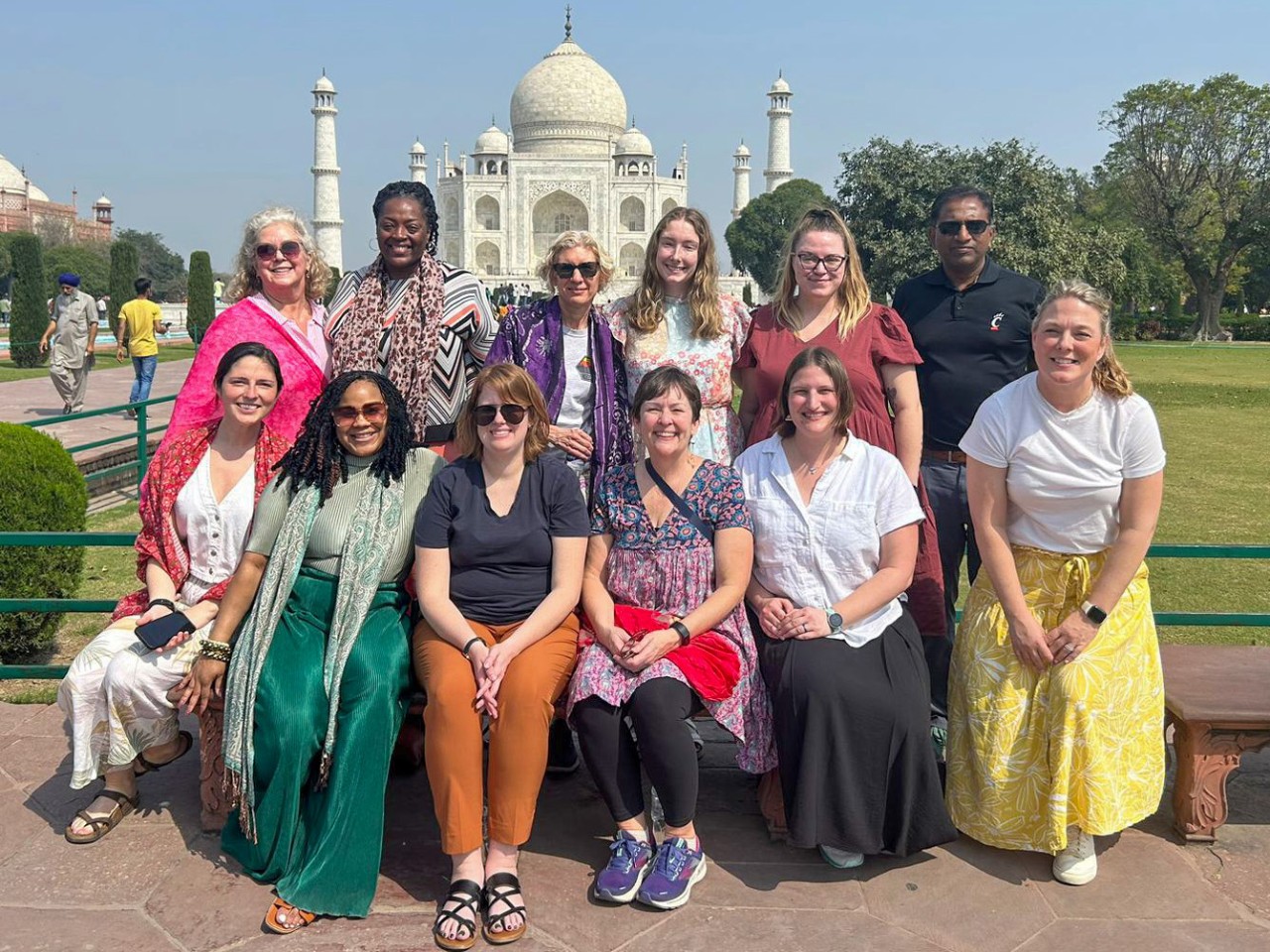 A group poses in front of the Taj Mahal