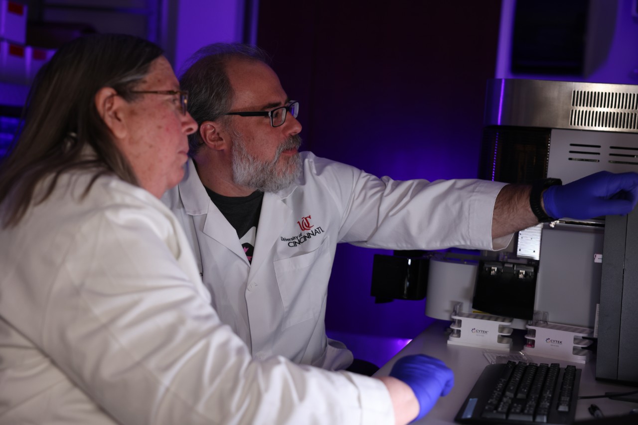 Two researchers look and point at a screen