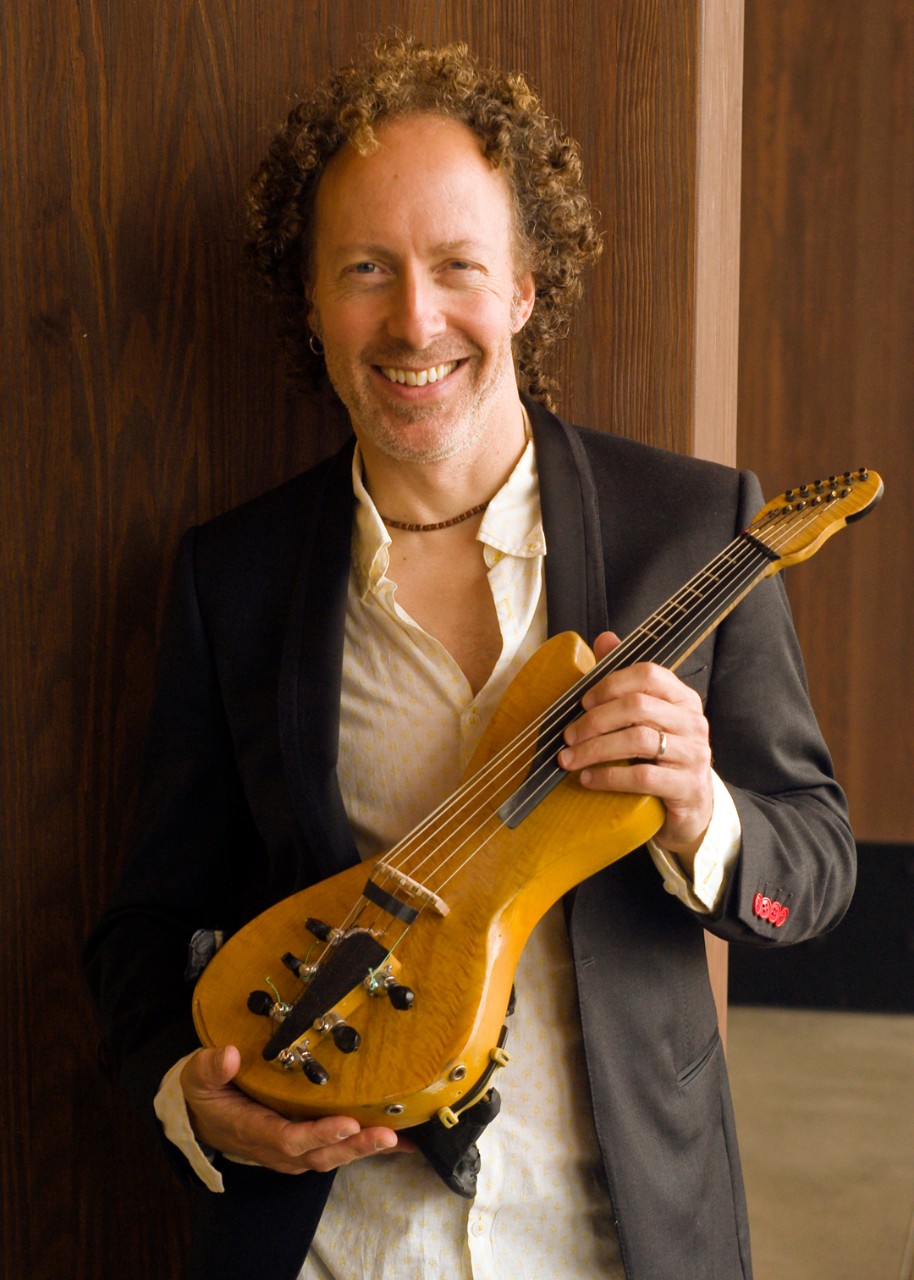 A photograph of Tracy Silverman holding a violin. Photo/Martin Cherry