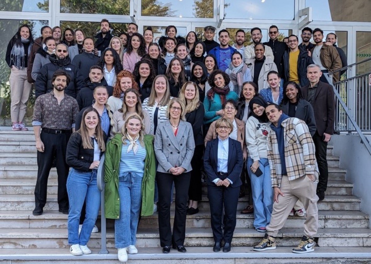 students and faculty standing on steps of IFITS