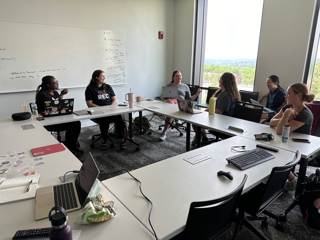 several students seated around a table in discussion